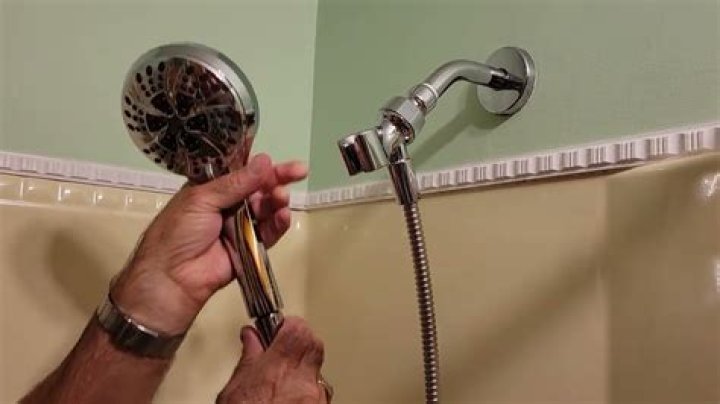 How do I remove buildup from my shower head?