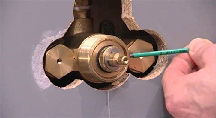 How do you clean a thermostatic shower valve?