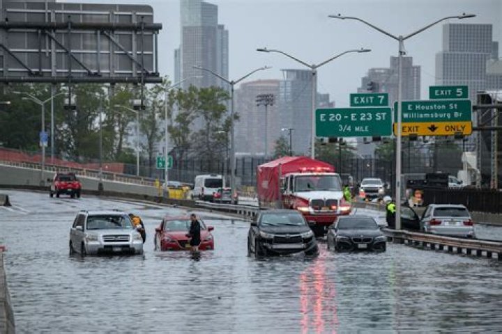 Why are cities prone to flooding during heavy rains?